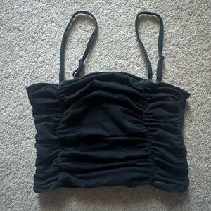 Black, size medium cropped tank with rouging. Fit is tight and crop is short